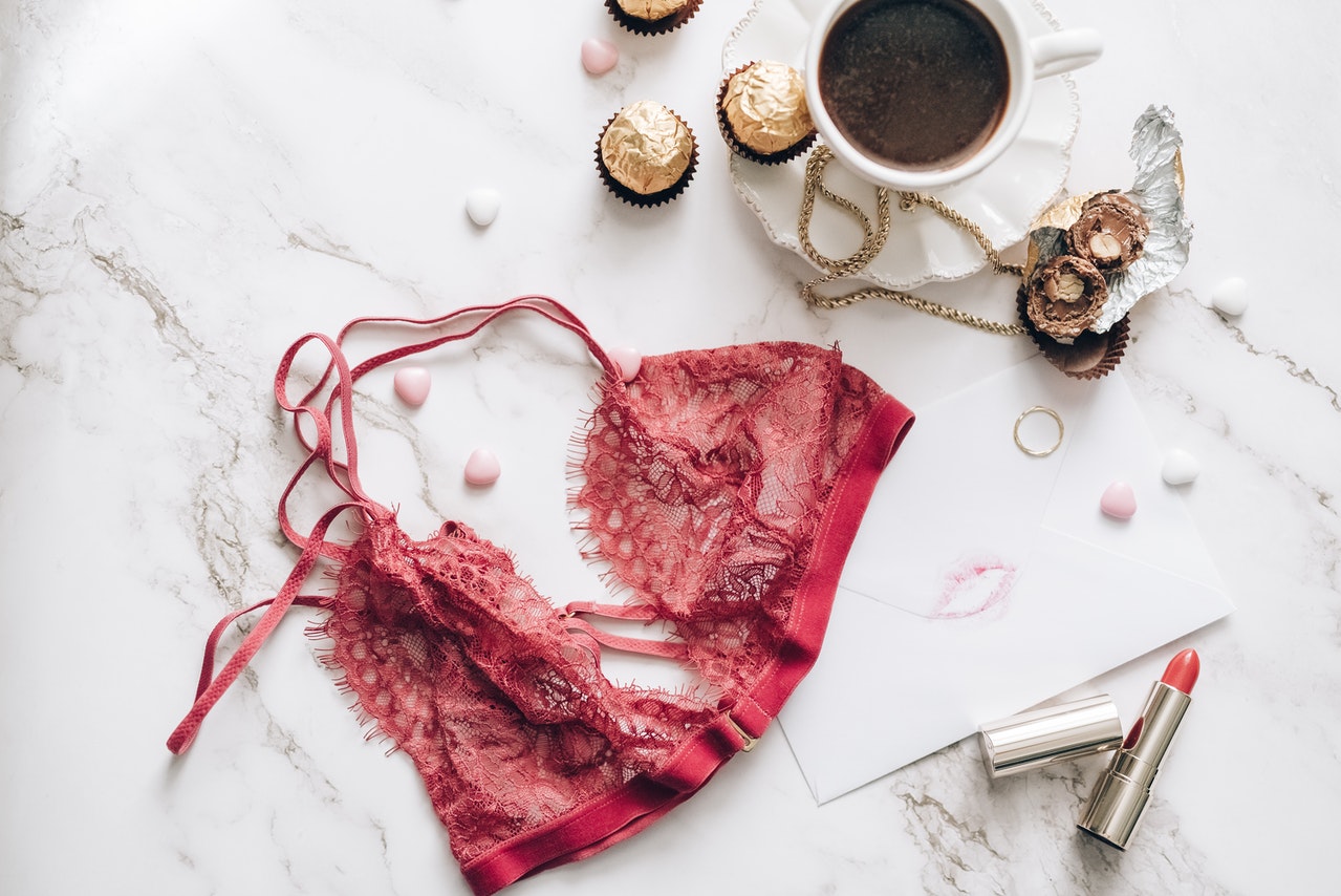 Beautiful red bra next to the cup of coffee