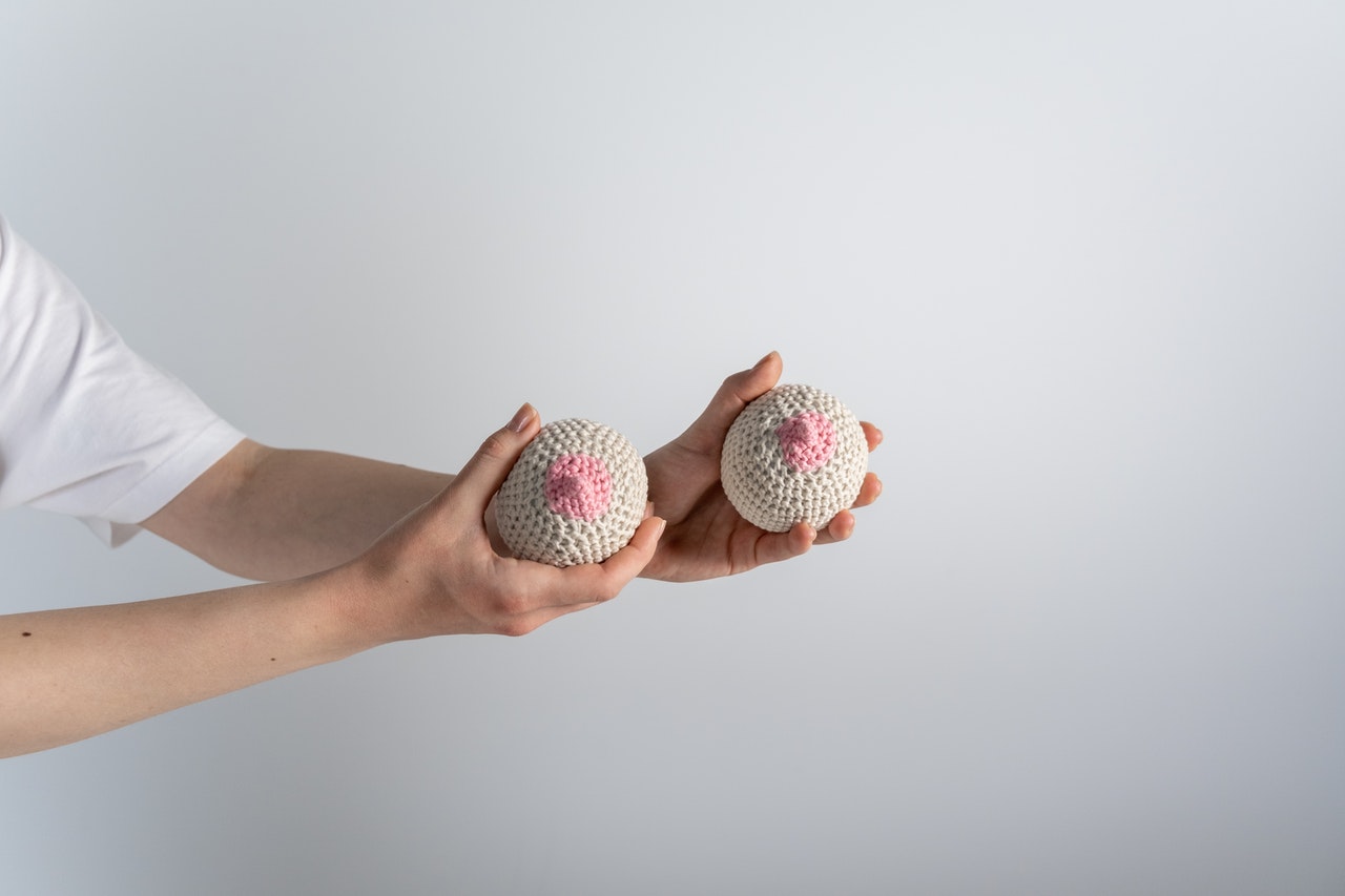 Woman is holding hand made boob toys